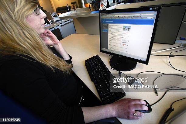 Woman sits on February 28, 2011 in Tallinn in front of a computer to vote in the Estonian general election. Data showed on March 3 that a record...