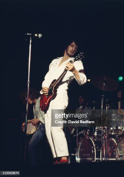 English guitarist Pete Townshend, wearing his trademark white boiler suit, performs live on stage playing a Gibson SG Special guitar, with rock group...