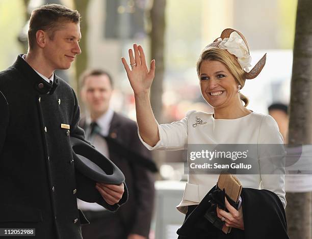 Princess Maxima of the Netherlands waves upon her arrival at the Adlon Hotel as a bellboy looks on on April 12, 2011 in Berlin, Germany. The Dutch...