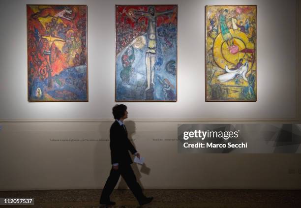 Member of staff walks in front of "Resistence, Resurrection and Liberation" by Marc Chagall at the Museo Palazzo Forti on April 12, 2011 in Verona,...