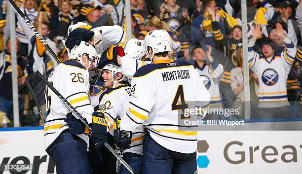 Nathan Gerbe of the Buffalo Sabres celebrates his third period goal against the Philadelphia Flyers with teammates Thomas Vanek and Steve Montador at...