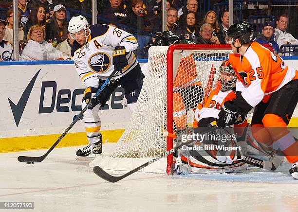 Thomas Vanek of the Buffalo Sabres caqrries the puck against Sergei Bobrovsky and Matt Carle of the Philadelphia Flyers at HSBC Arena on March 8,...