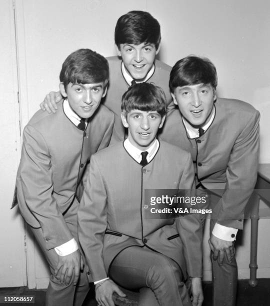 The Beatles pose for an early group portrait wearing Pierre Cardin collarless jackets, George Harrison, Paul McCartney, John Lennon, Ringo Starr,...