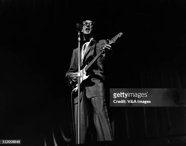 Buddy Holly, performs on stage, playing Fender Stratocaster guitar, 25 March 1958.