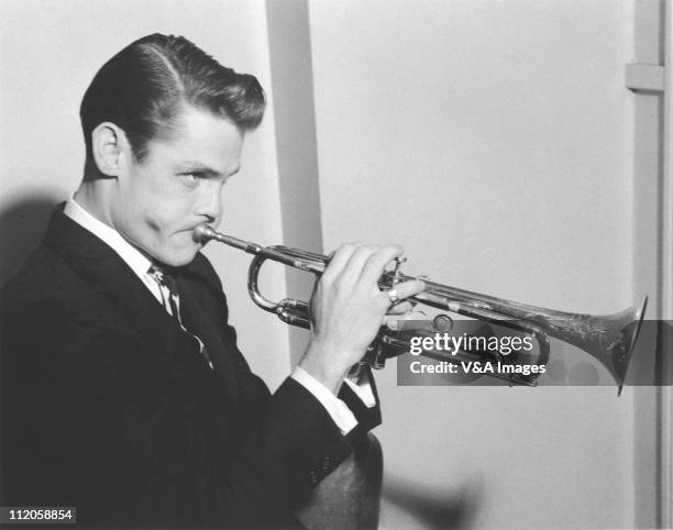 Chet Baker, posed, with trumpet, 1955.