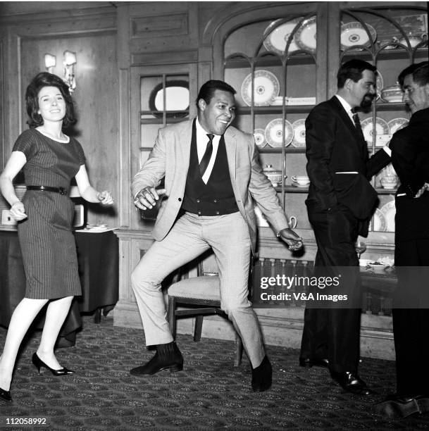 Chubby Checker, doing the twist at press reception, 1960.