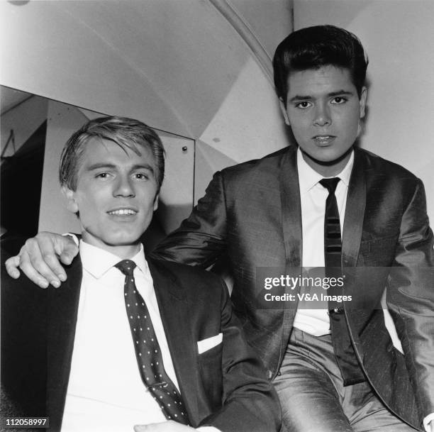 Adam Faith and Cliff Richard, posed, backstage, 1960.