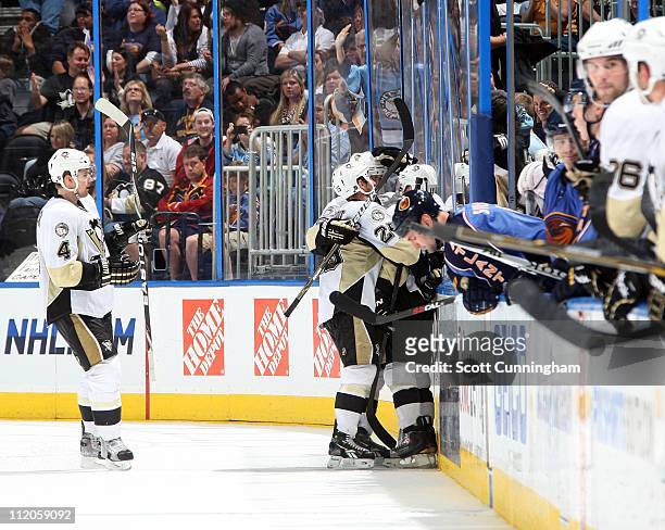 Mike Comrie of the Pittsburgh Penguins is congratulated by teammates after scoring an empty net goal against the Atlanta Thrashers at Philips Arena...