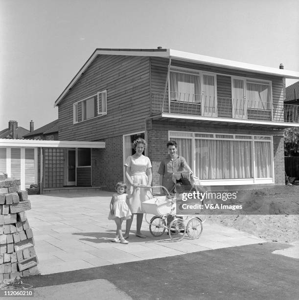 Lonnie Donegan, posed, with wife Maureen Tyler and two children, at home, 1960.