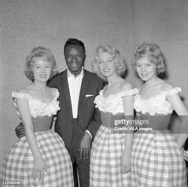 Nat King Cole, posed with Beverley Sisters, 1959.