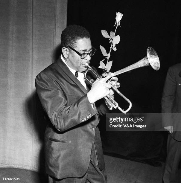 Dizzy Gillespie, posed, with rose and trumpet, 1959.