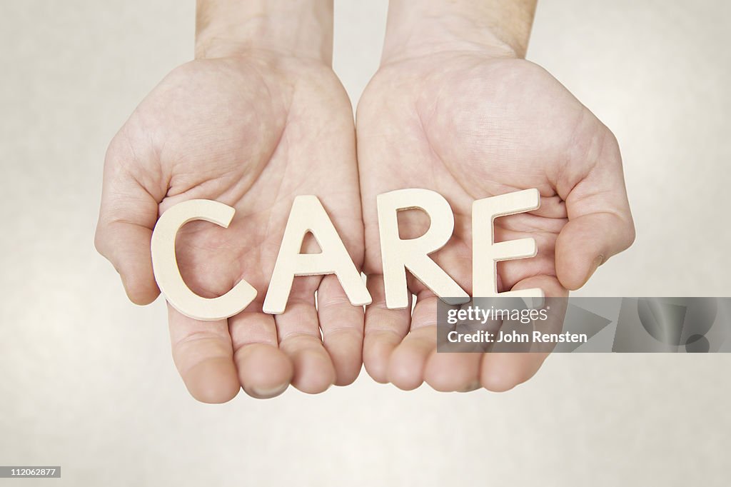 Hands holding letters spelling words