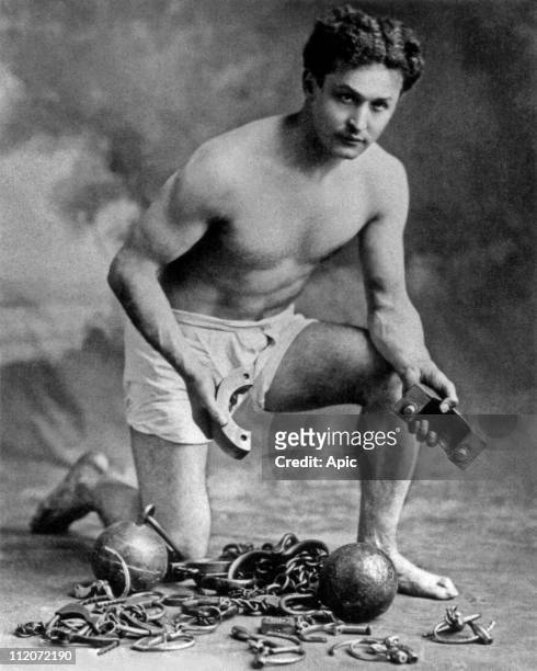 Harry Houdini american conjuror, here with chains, c. 1906.