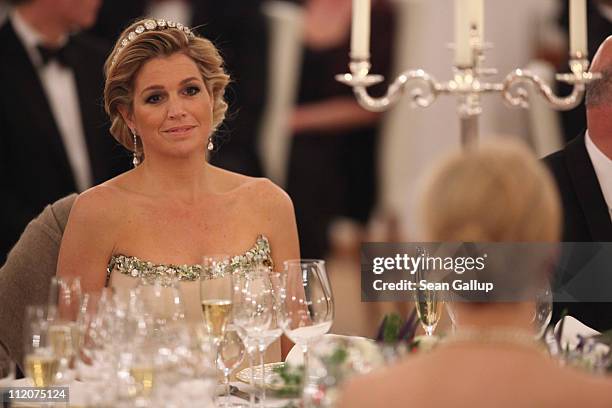 Princess Maxima of the Netherlands looks over at German First Lady Bettina Wulff as they attend a state banquet given in honour of the visiting Dutch...