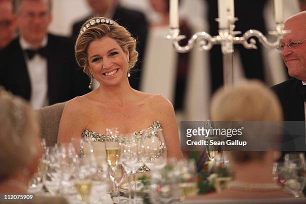 Princess Maxima of the Netherlands looks over at German First Lady Bettina Wulff as they attend a state banquet given in honour of the visiting Dutch...