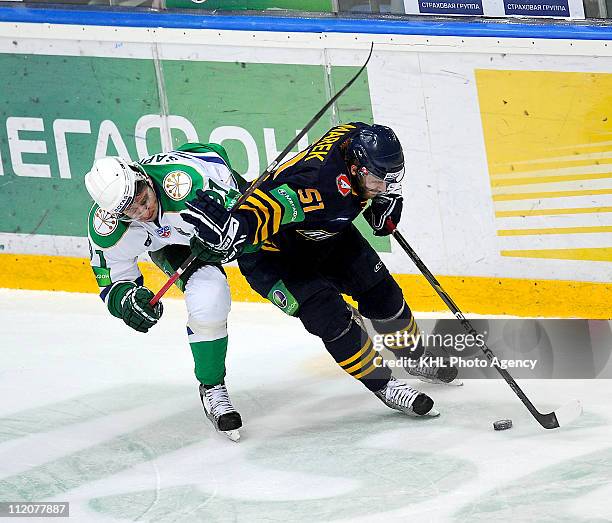 Jan Marek of the Atlant Mytishchi skates with the puck under pressure from Oleg Saprykin of the Salavat Yulaev Ufa during the Game Three of the 2011...