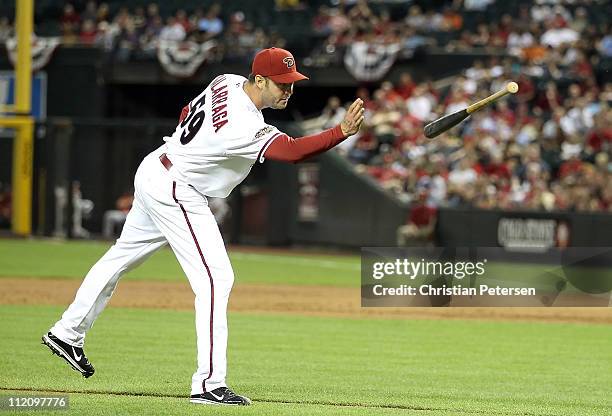 Starting pitcher Armando Galarraga of the Arizona Diamondbacks throws a bat back to Yadier Molina of the St. Louis Cardinals during the Major League...