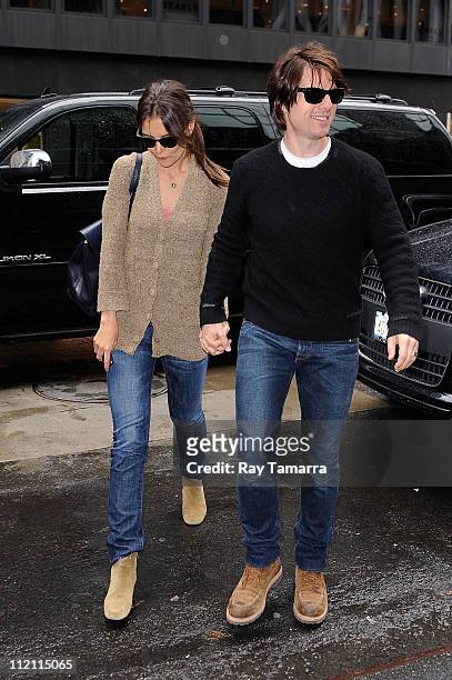 Actors Katie Holmes and Tom Cruise enter a Midtown Manhattan office building on April 12, 2011 in New York City.