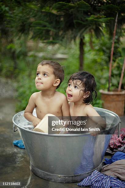 children in metal bath - washing tub stockfoto's en -beelden