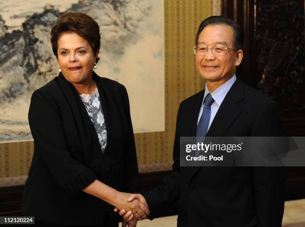 Chinese premier Wen Jiabao shakes hands with Brazilian President Dilma Vana Rousseff on April 13, 2011in Beijing, China. The Brazilian President is...