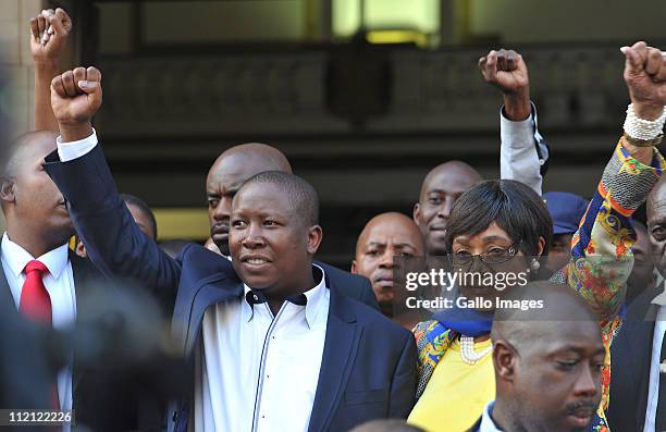 Youth League president Julius Malema and ANC stalwart Winnie Madikizela-Mandela raise their fists as they leave the High Court on April 12, 2011 in...