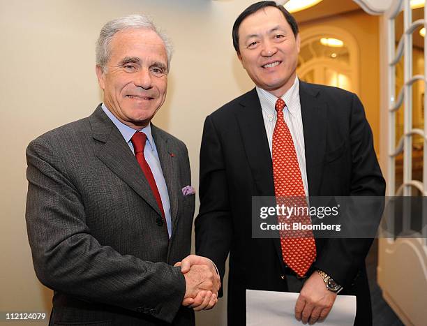 Philippe Louis-Dreyfus, president of Louis Dreyfus Armateurs SAS, left, shakes hands with Dong Qiang, vice president of China Shipbuilding Industry...