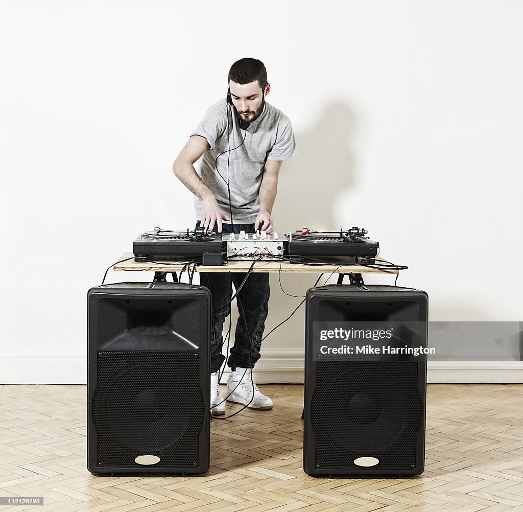 Male DJ Using Decks