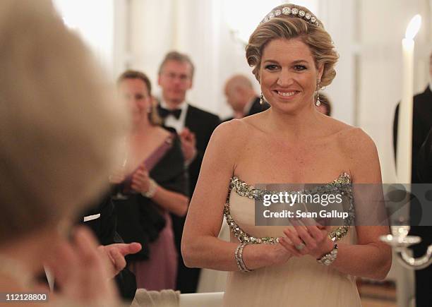 Princess Maxima of the Netherlands looks to her mother-in-law, Queen Beatrix, while attending a state banquet given in honour of the visiting Dutch...