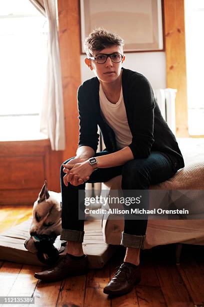 person sitting on bed with dog by feet - michael sit stock pictures, royalty-free photos & images