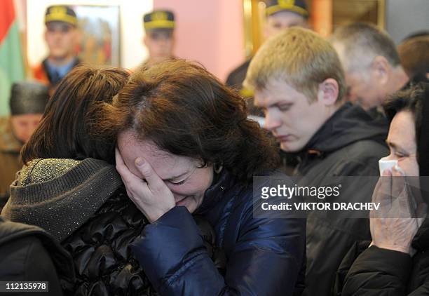 Relatives of Galina Pikulik, a victim of the Minsk metro bombing that killed 12 and wounded 200 on April 11, cry during a funeral ceremony in Minsk...