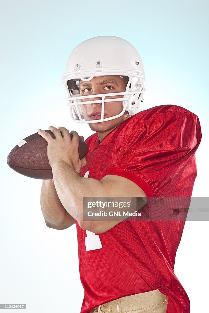 Football Player with ball in studio