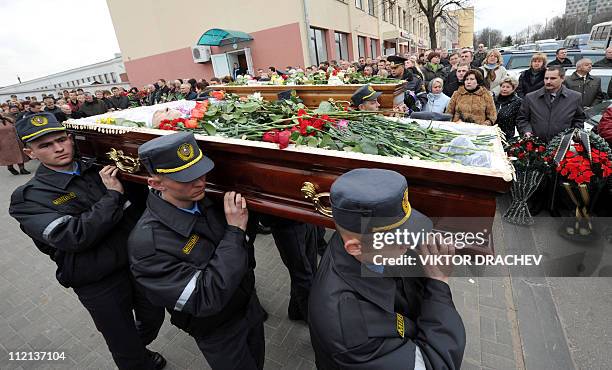 Belarussian policemen carry the coffins of Galina Pikulik and Anatoliy Narkevich, victims of the Minsk metro bombing that killed 12 and wounded 200...