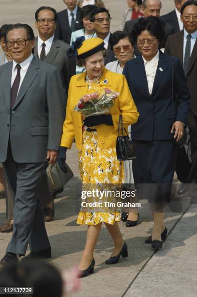 Queen Elizabeth II, wearing an outfit and hat designed by fashion designer Ian Thomas, on a walkabout in Shanghai, during an official State Visit to...