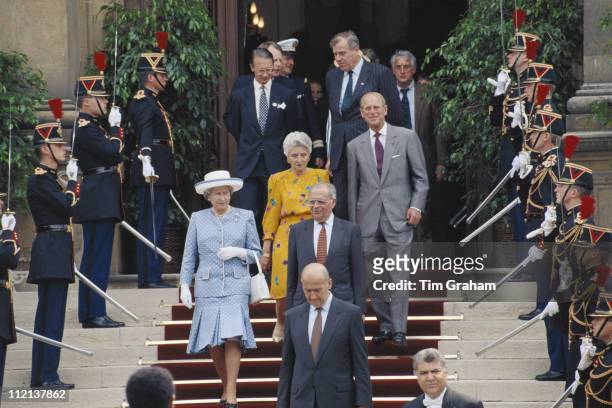 Queen Elizabeth II and Prince Philip walking through a guard of honour, in Paris, while on an official state visit to France, 10 June 1992.