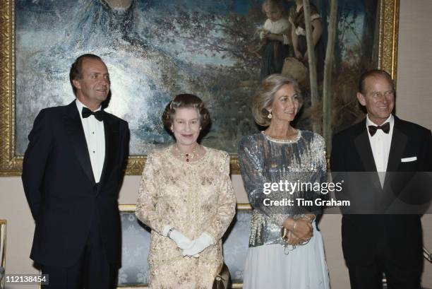 Prince Philip, Queen Elizabeth II, Queen Sofia of Spain, and King Juan Carlos I of Spain, at El Pardo Palace, in Madrid, for a state banquet in...