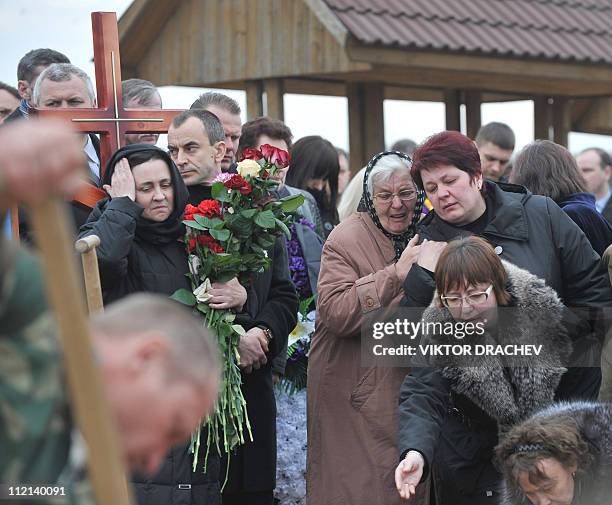 Relatives of Galina Pikulik, a victim of the Minsk metro bombing that killed 12 and wounded 200 on April 11, mourn during the funeral ceremony in...