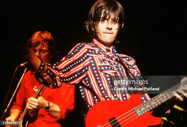 Nick Lowe and Dave Edmunds of Rockpile perform on stage, New York, August 1979. Lowe plays a Hamer 8 string bass guitar.