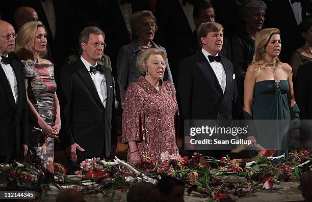 German First Lady Bettina Wulff and President Christian Wulff stand silent as Queen Beatrix, Prince Willem-Alexander and Princess Maxima of the...