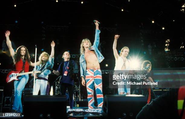 Def Leppard perform on stage with Brian May at Freddie Mercury Tribute Concert, Wembley, London, 20th April 1992, L-R Vivian Campbell, Rick Savage,...