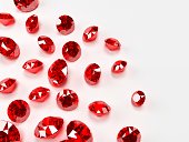 Many red rubies on a white surface