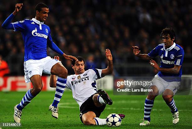 Joel Matip and Raul Gonzalez of Schalke are challenged by Dejan Stankovic of Inter during the UEFA Champions League quarter final second leg match...