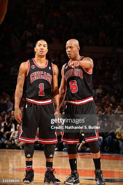 Derrick Rose of the Chicago Bulls talks with teammate Keith Bogans during a game against the New York Knicks on April 12, 2011 at Madison Square...