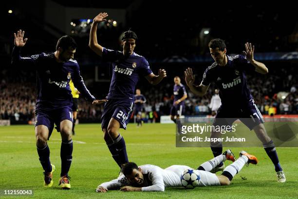 Sandro of Spurs lies on the ground as Raul Albiol , Mesut Ozil and Alvaro Arbeloa of Real Madrid react during the UEFA Champions League quarter final...