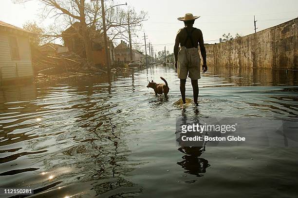 Paul Garrett and his neighbor's dog, Rusty, whom he rescued during Hurricane Katrina, walk the streets of the 9th ward on their way home. "Everybody...