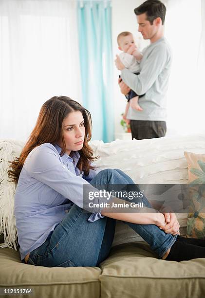 mother unhappy, father and baby in background - baby depression fotografías e imágenes de stock