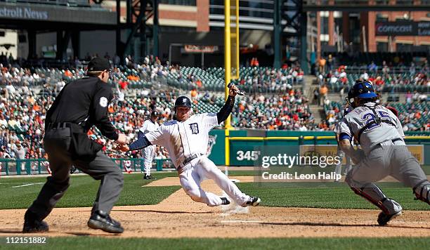 Brennan Boesch of the Detroit Tigers scores on a sacrifice fly by Brandon Inge to tie the game in the sixth inning during the game at Comerica Park...
