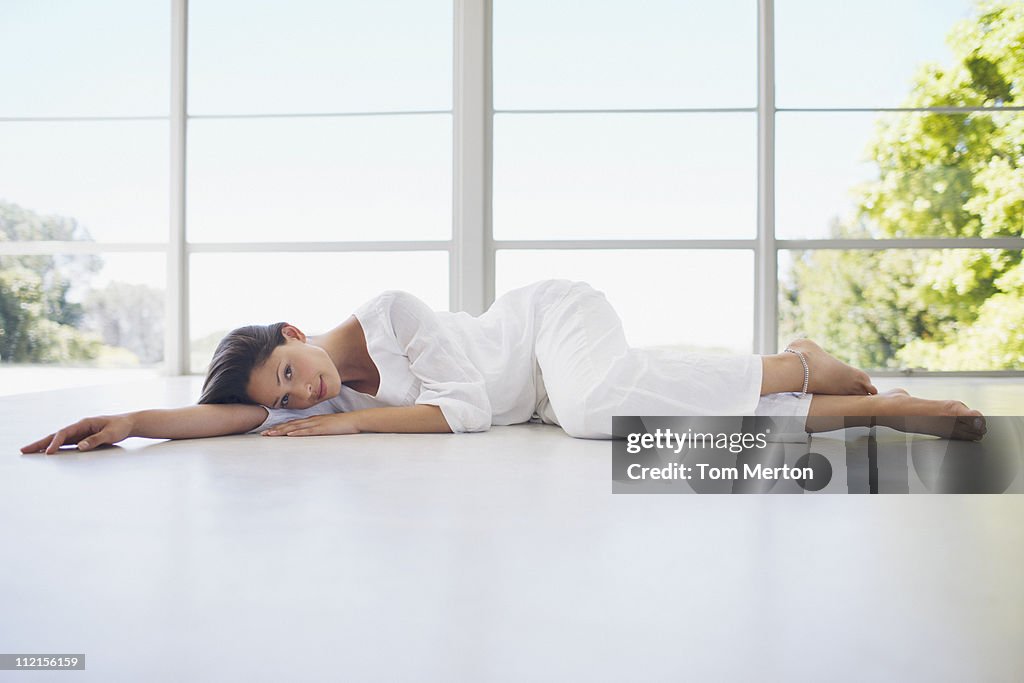 Serene woman laying on floor