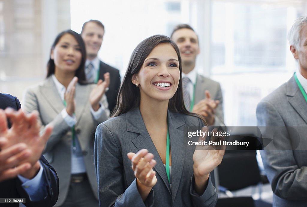 Business people clapping in seminar