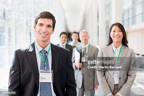 business people standing in office - lanyard stockfoto's en -beelden