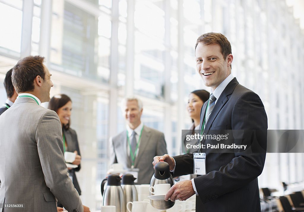 Business people drinking coffee in office